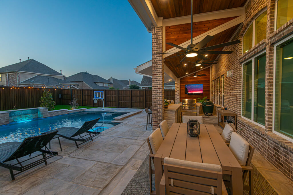 Pool, covered patio, and outdoor kitchen in Roanoke Texas